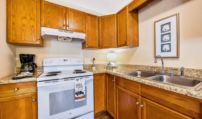 Spacious kitchen at Meadow Creek Townhomes Spacious L shape kitchen with stove and sink at Meadow Creek Townhomes
