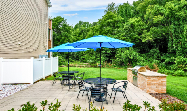 Grilling space at Meadow Creek Townhomes Grilling space with umbrellas  at Meadow Creek Townhome